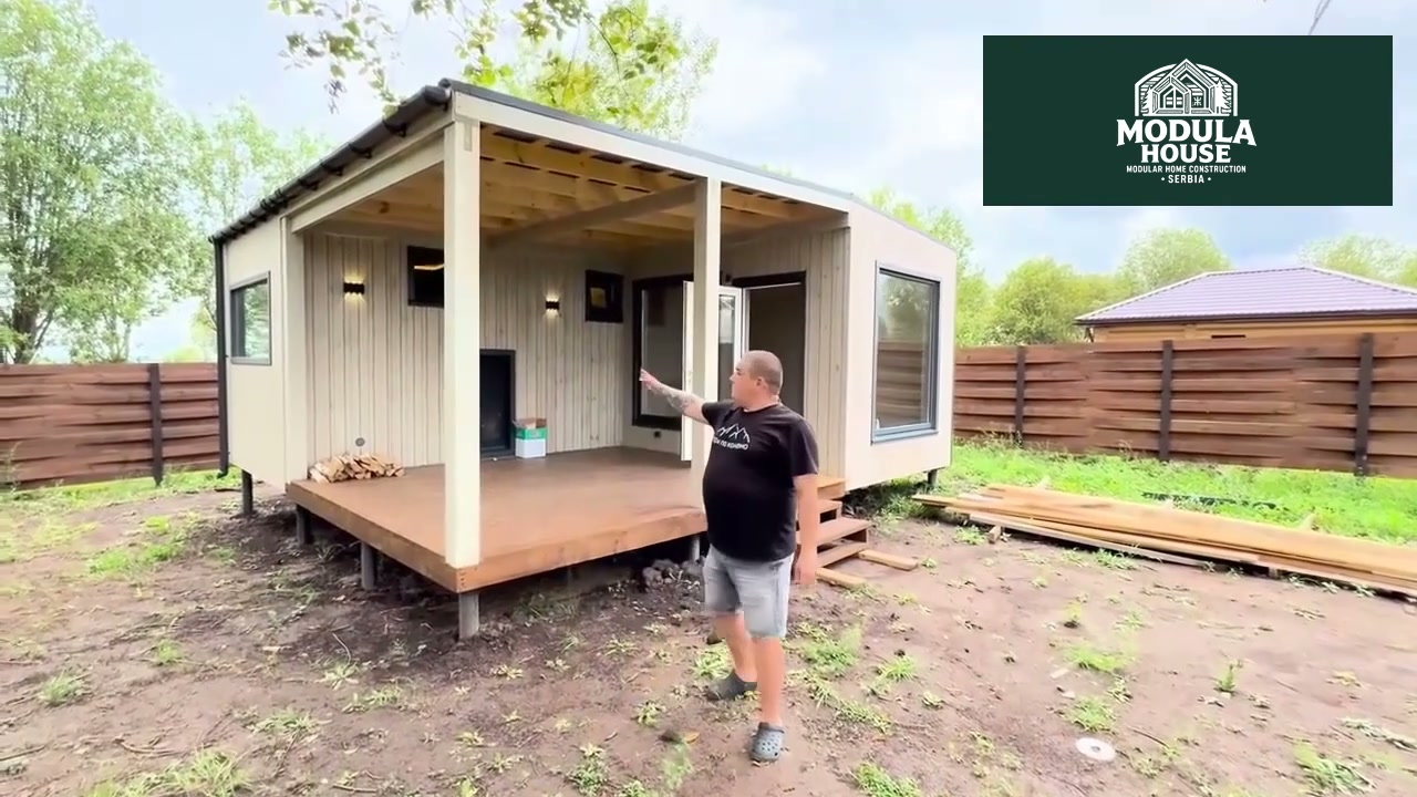 An L-shaped two-module sauna with a covered terrace